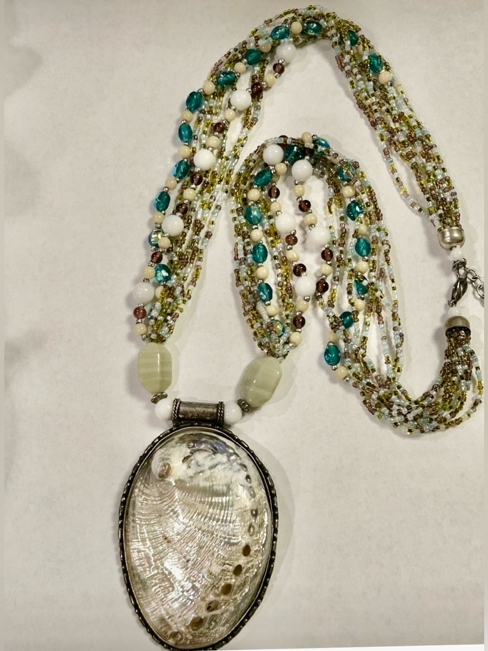 Vintage Artisan white shell pendant, hand-tooled bezel, newer multi-strand beads
